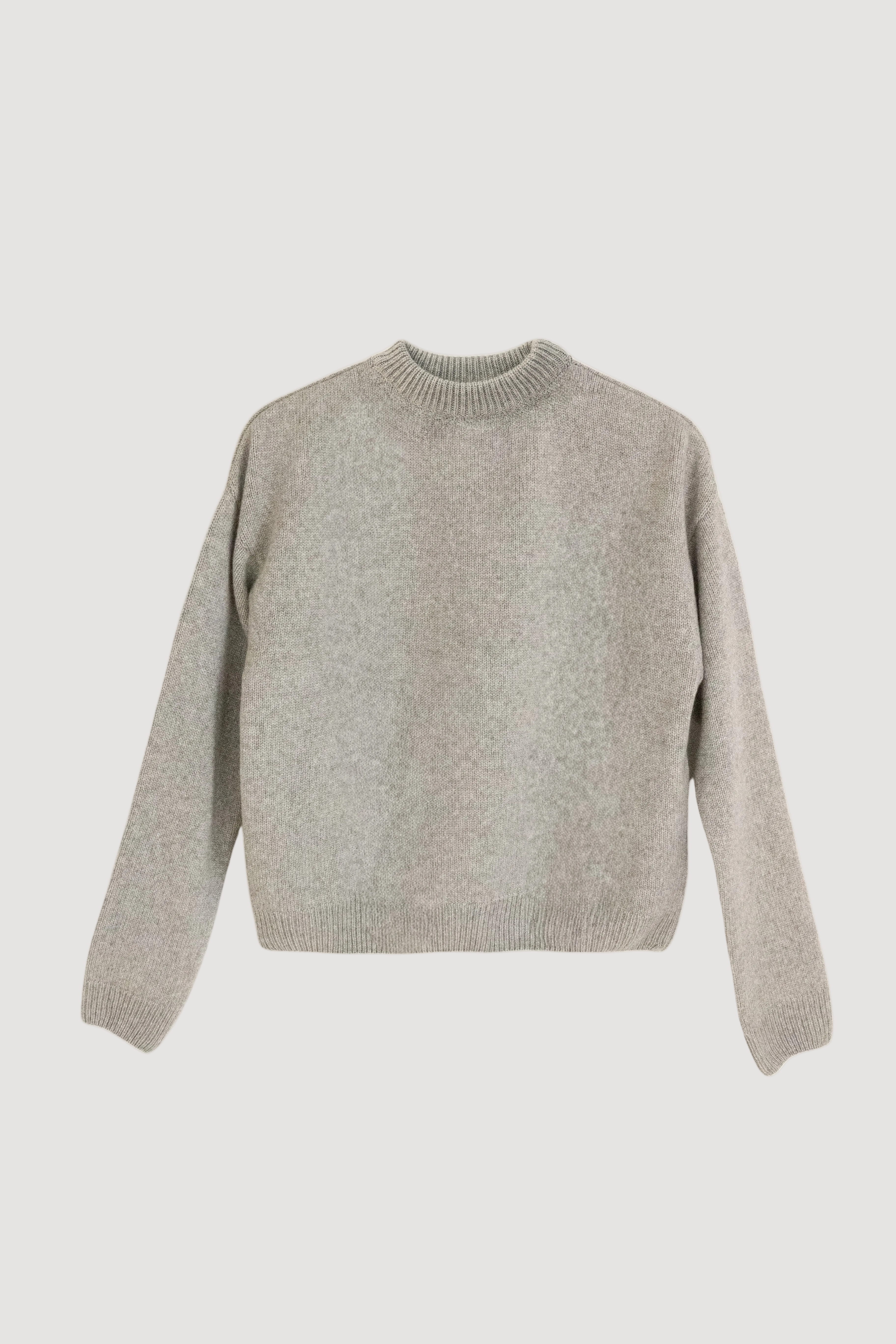 A gray crewneck sweater made of cashmere and silk, displayed on a plain background.