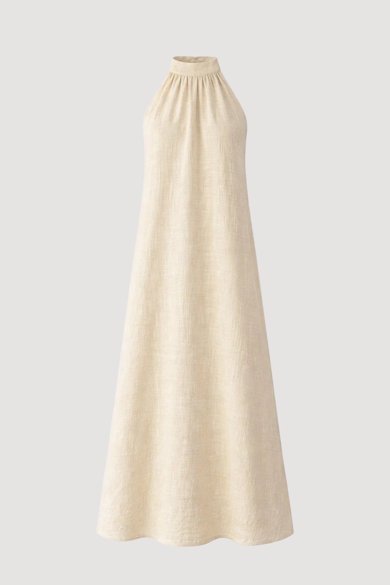 Beige halter neck dress on a white background