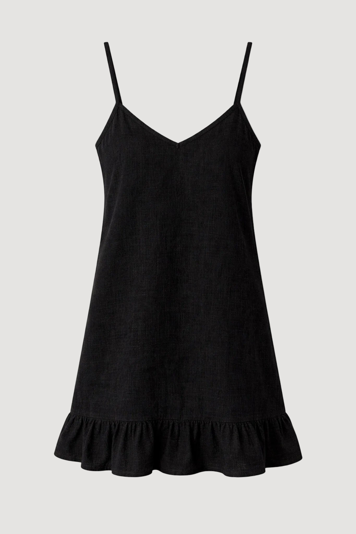 Black slip dress with ruffled hem on a white background