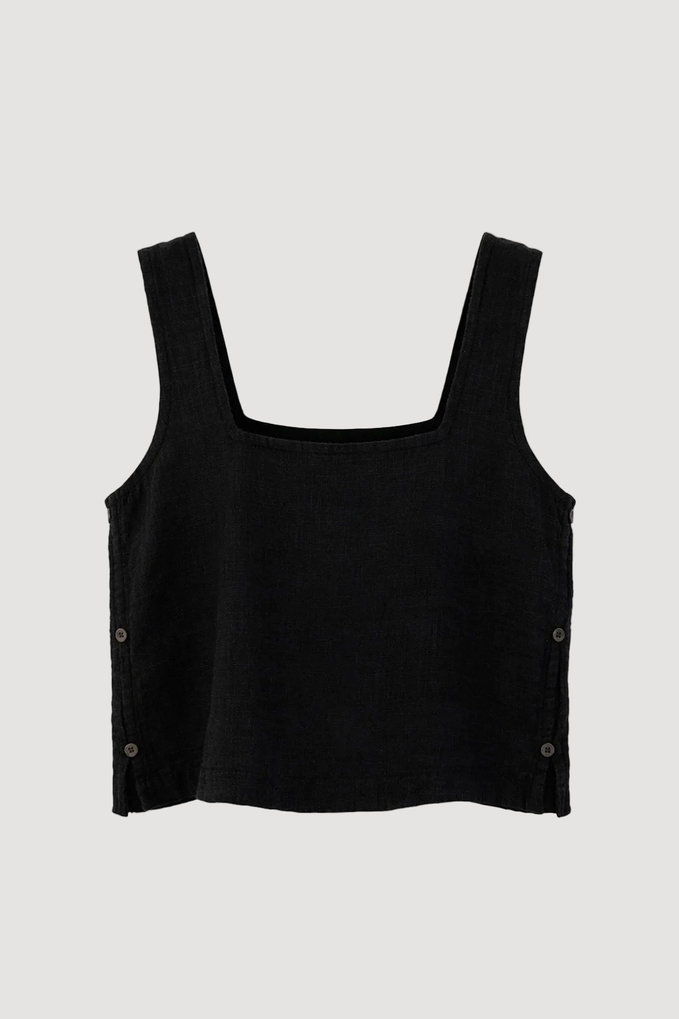 A black cropped tank top with a square neckline and wide shoulder straps, featuring decorative buttons on the sides, displayed against a light gray background.