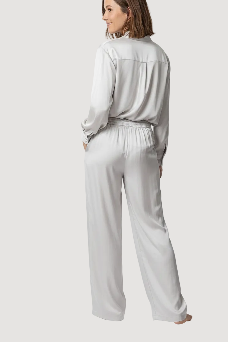 Woman wearing a light gray outfit on a white background