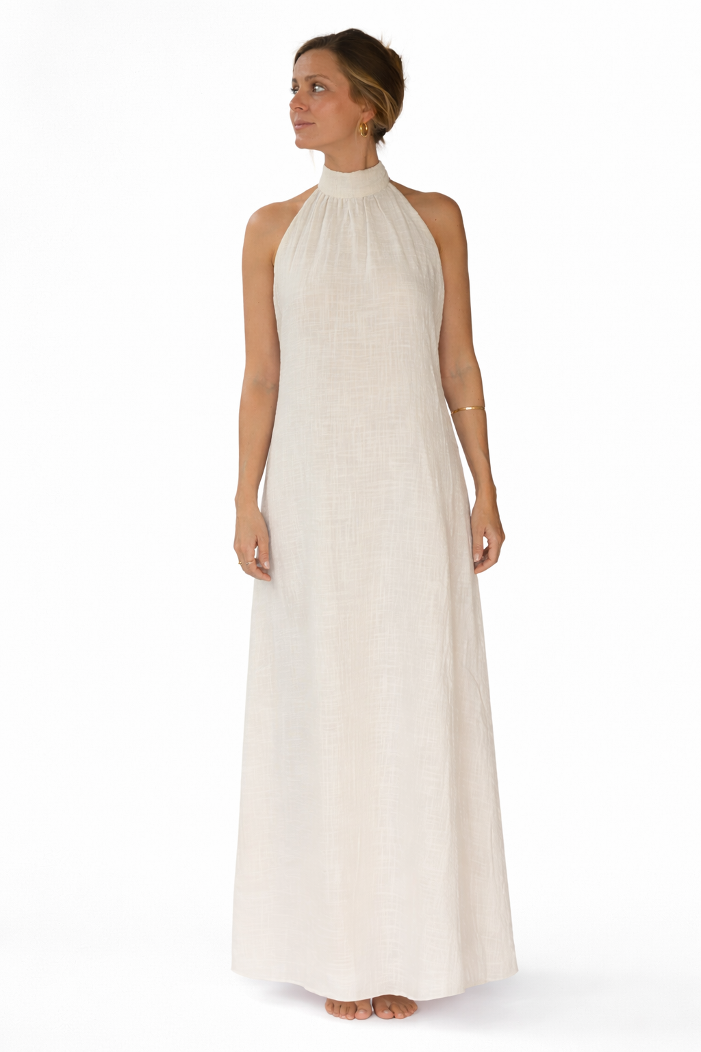 Woman wearing a long beige dress on a white background