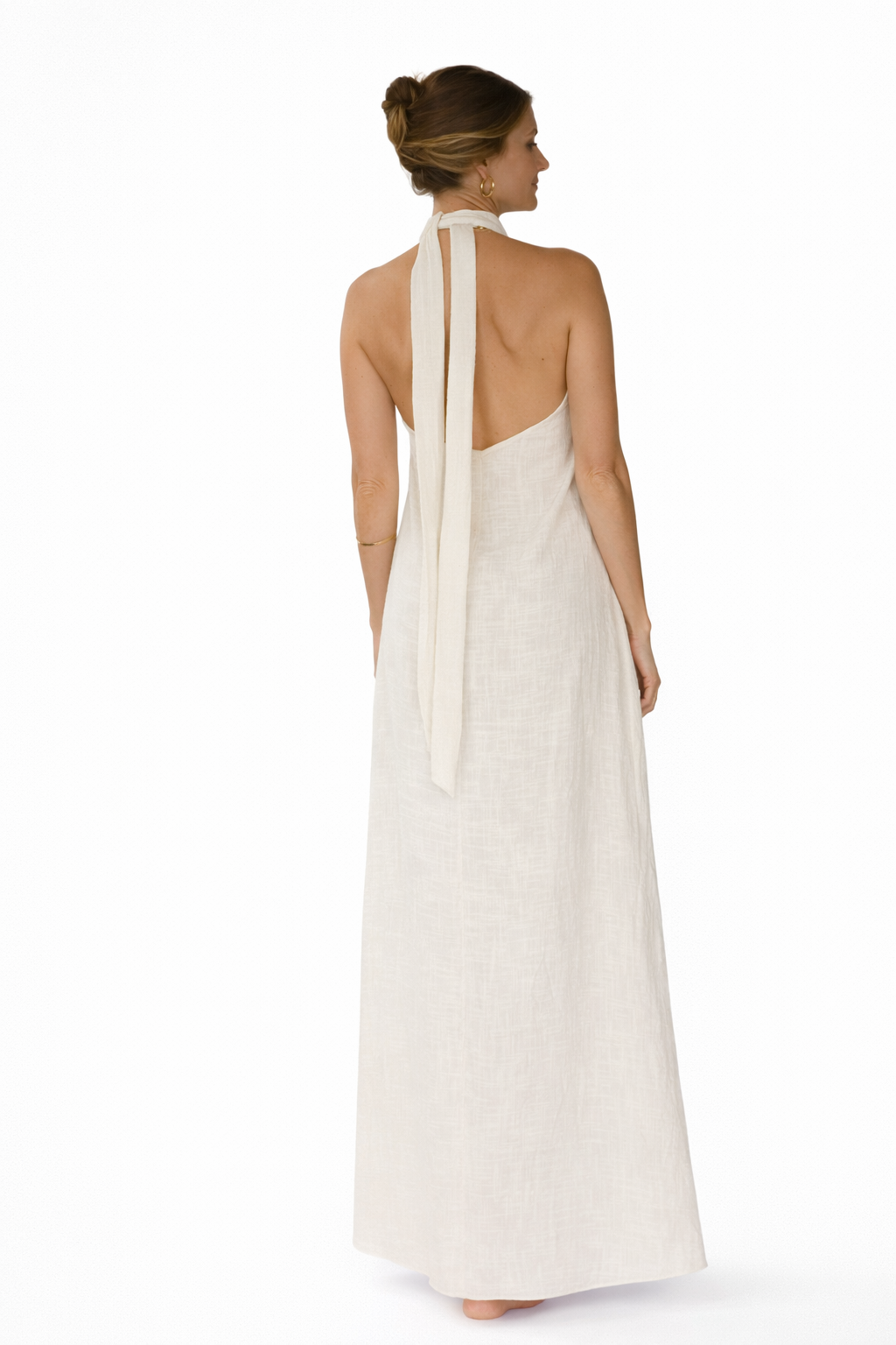 Woman wearing a white dress with a halter neck design on a white background