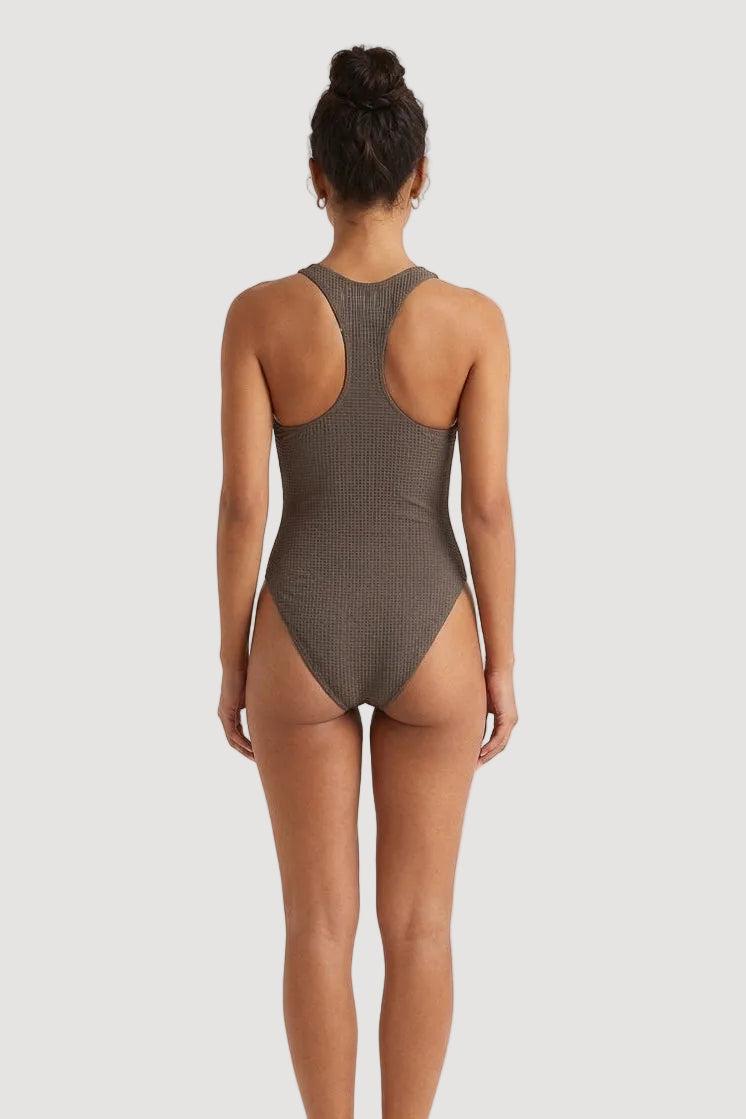 PURA Person wearing a ribbed brown one-piece maari swimsuit on a beige background back