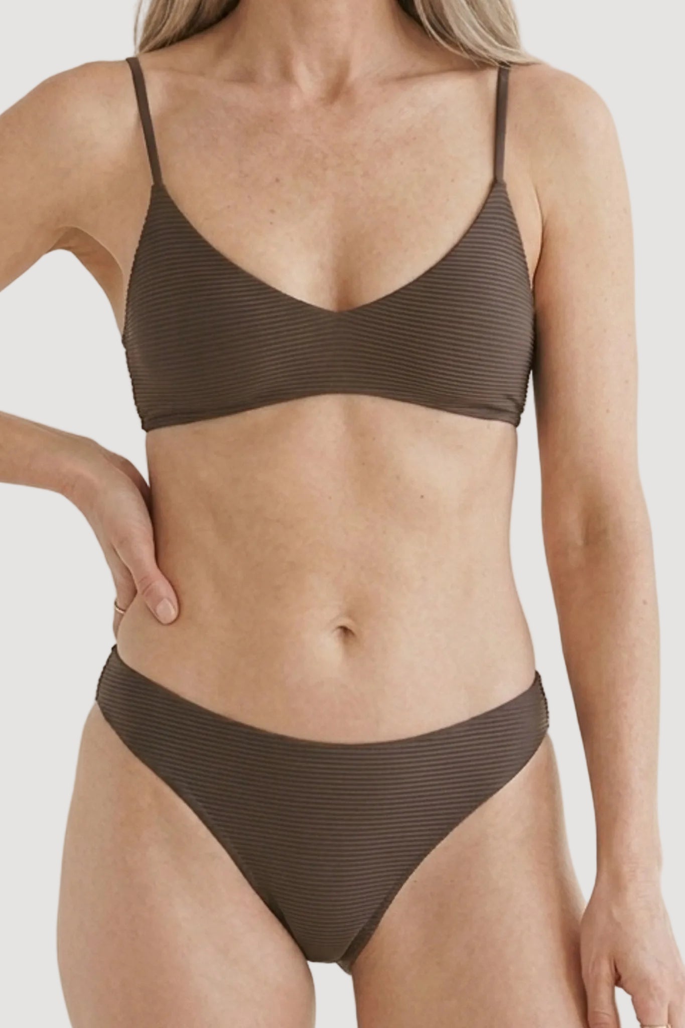 Person wearing a brown paloma bikini set against a neutral background
