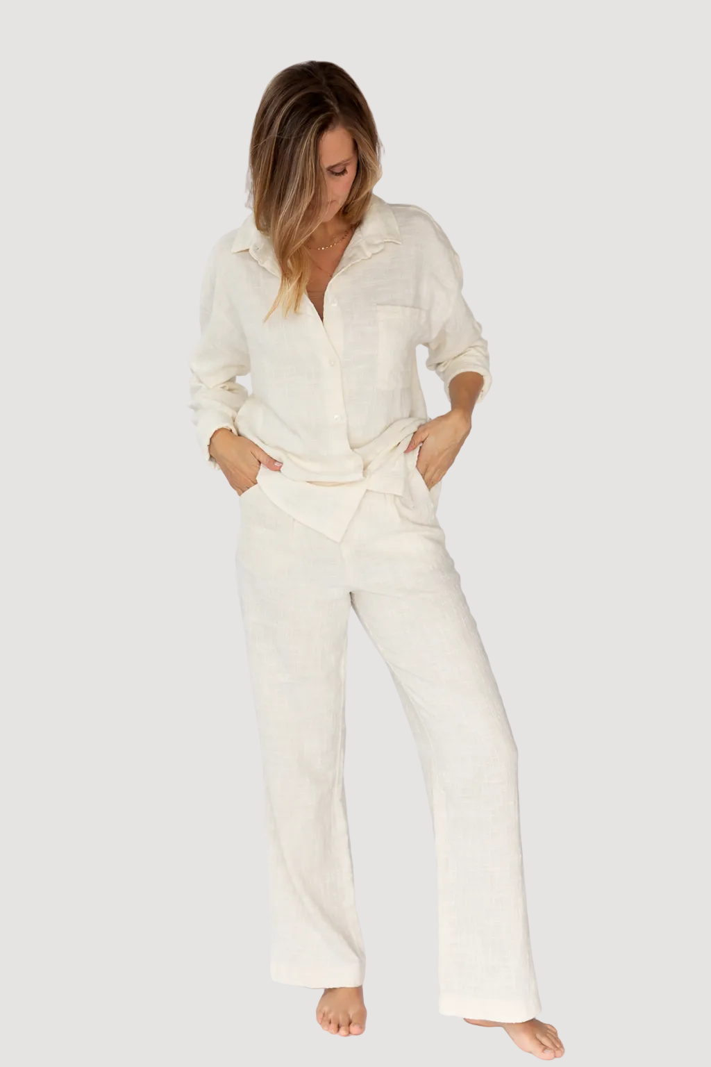 Woman wearing a white outfit on a white background
