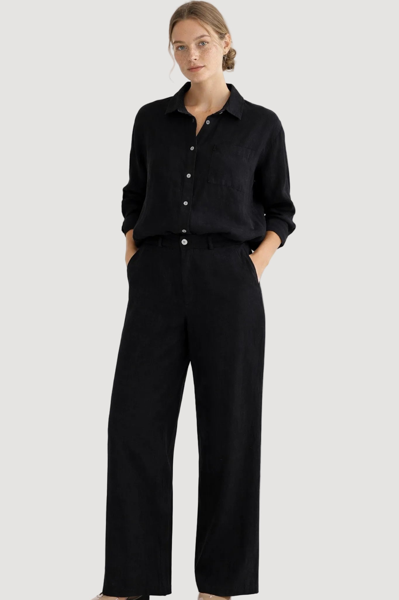 Woman wearing a black outfit on a white background