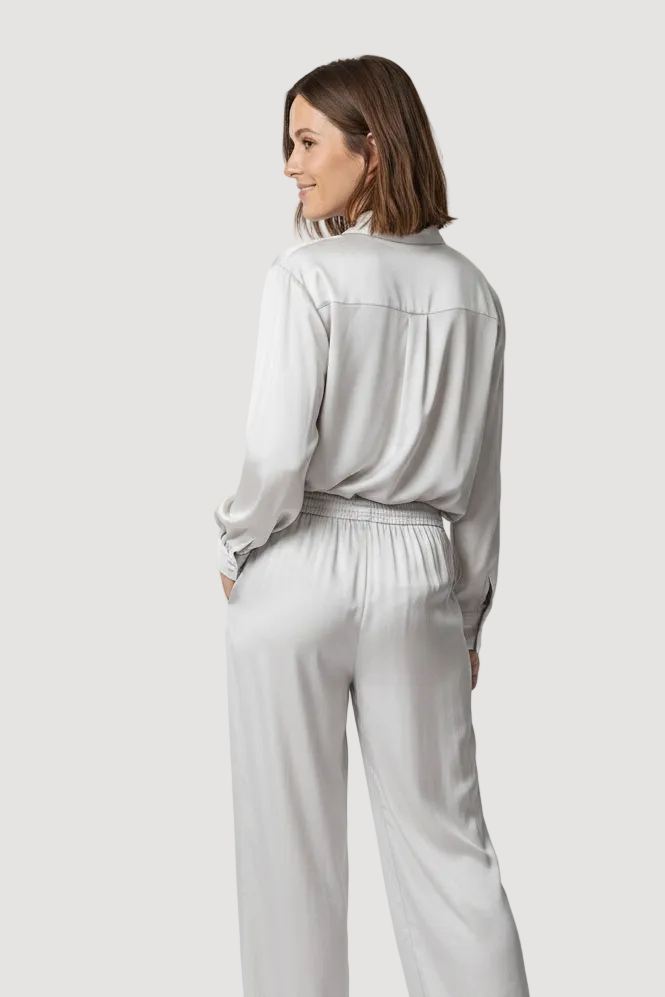 Woman wearing a light gray outfit on a white background