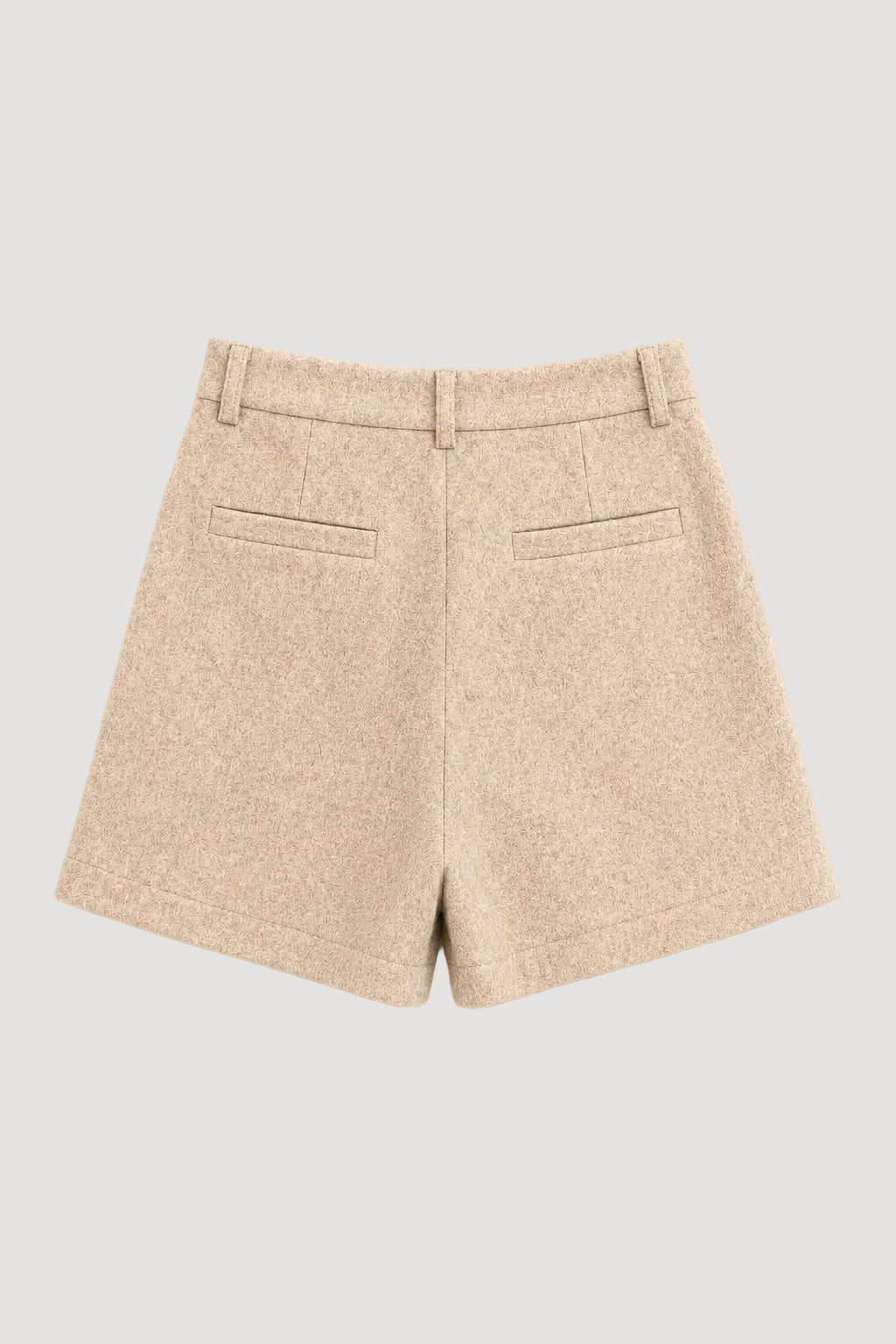 Beige textured wool shorts with two welt back pockets, shown from the back on a light cream background.