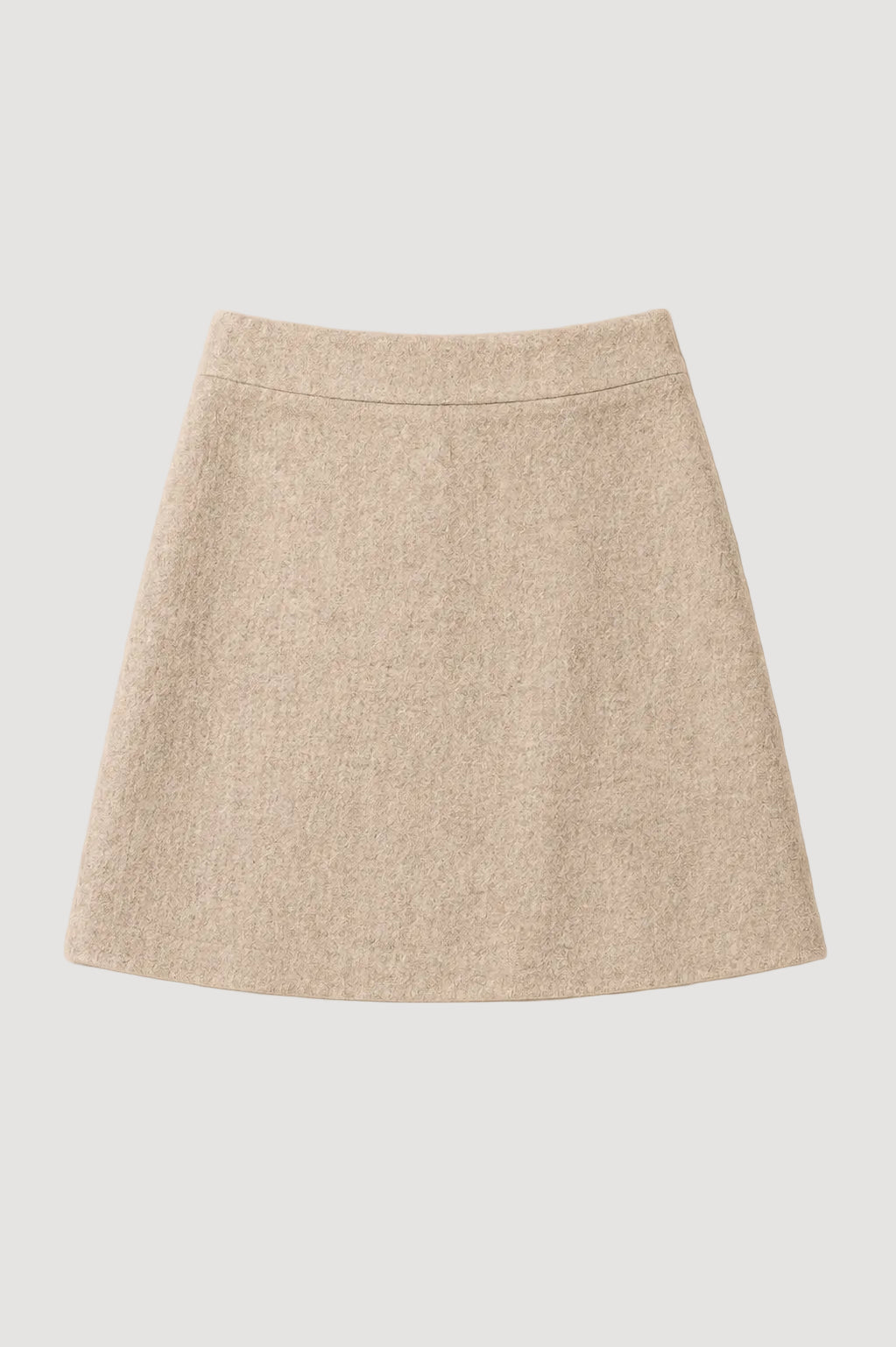 A light beige textured A-line mini skirt with a straight waistband, laid flat against a solid cream background.