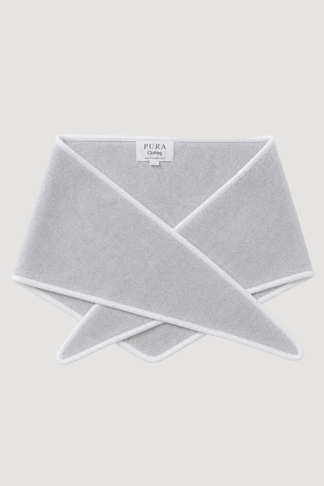 A light gray MERINO SCARFwith white trim, folded and displayed on a clean white background. The brand label 'PURA CLOTHING' is visible inside the fold.