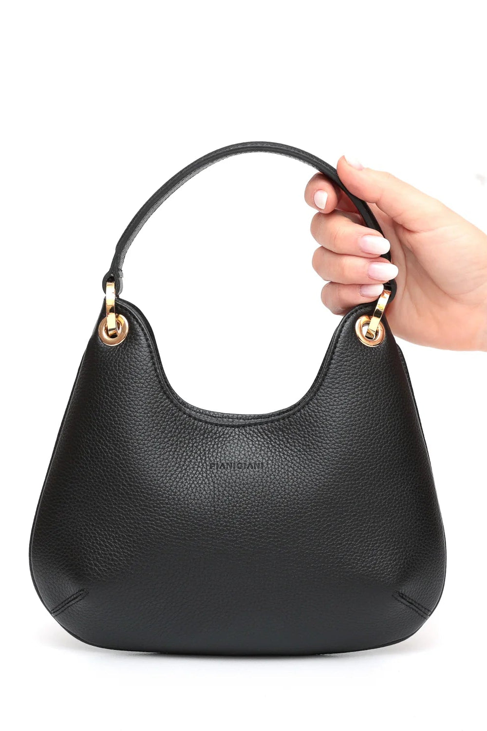 Black handbag held by a hand on a white background