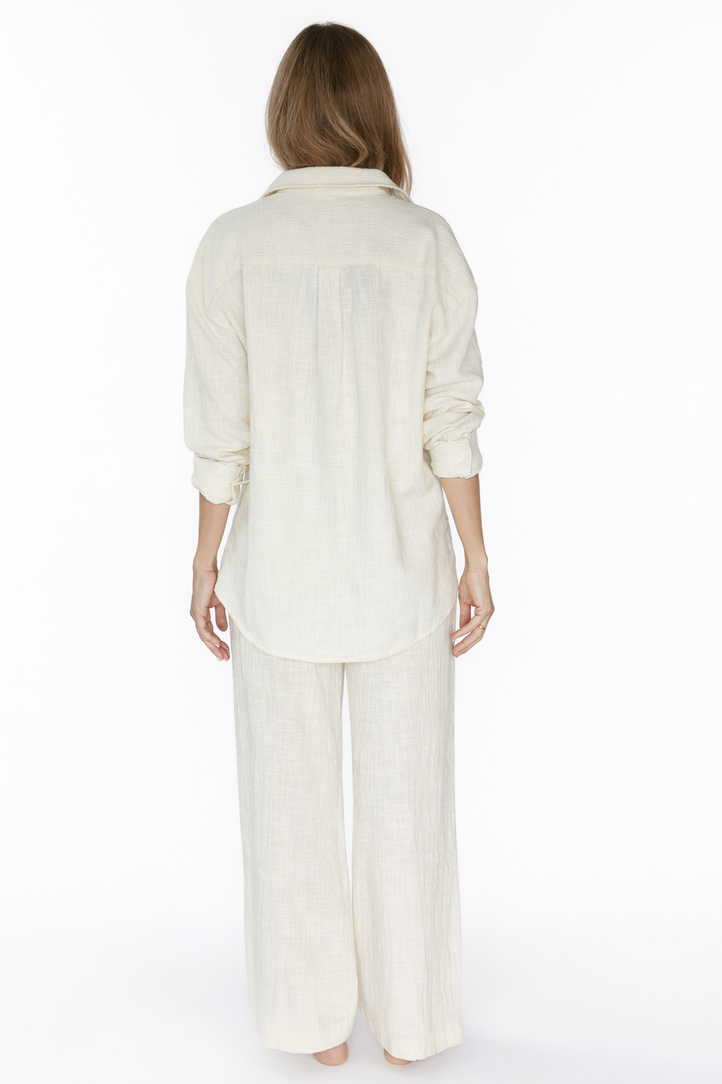 Person wearing a white outfit on a white background