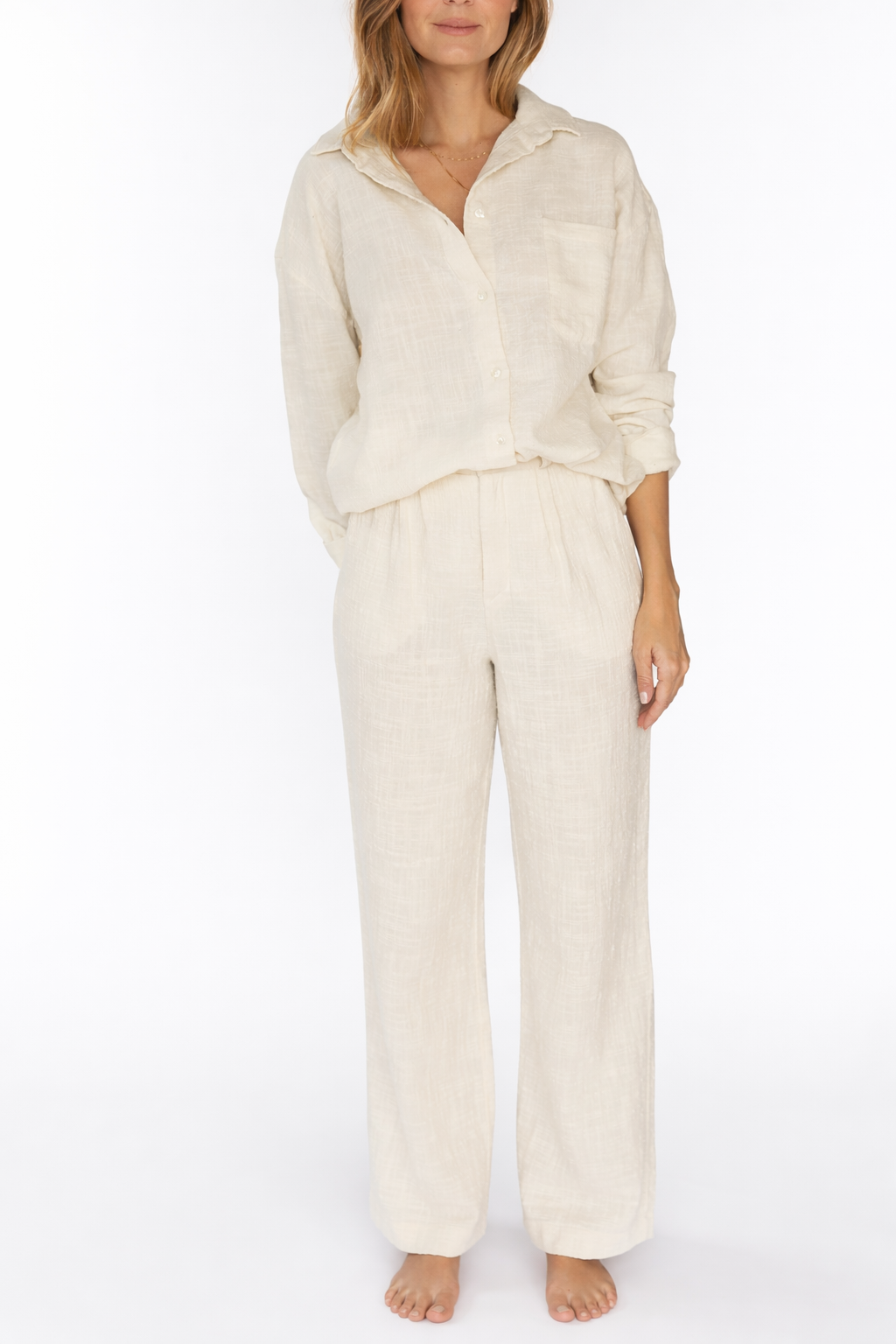 Woman wearing a beige outfit on a white background