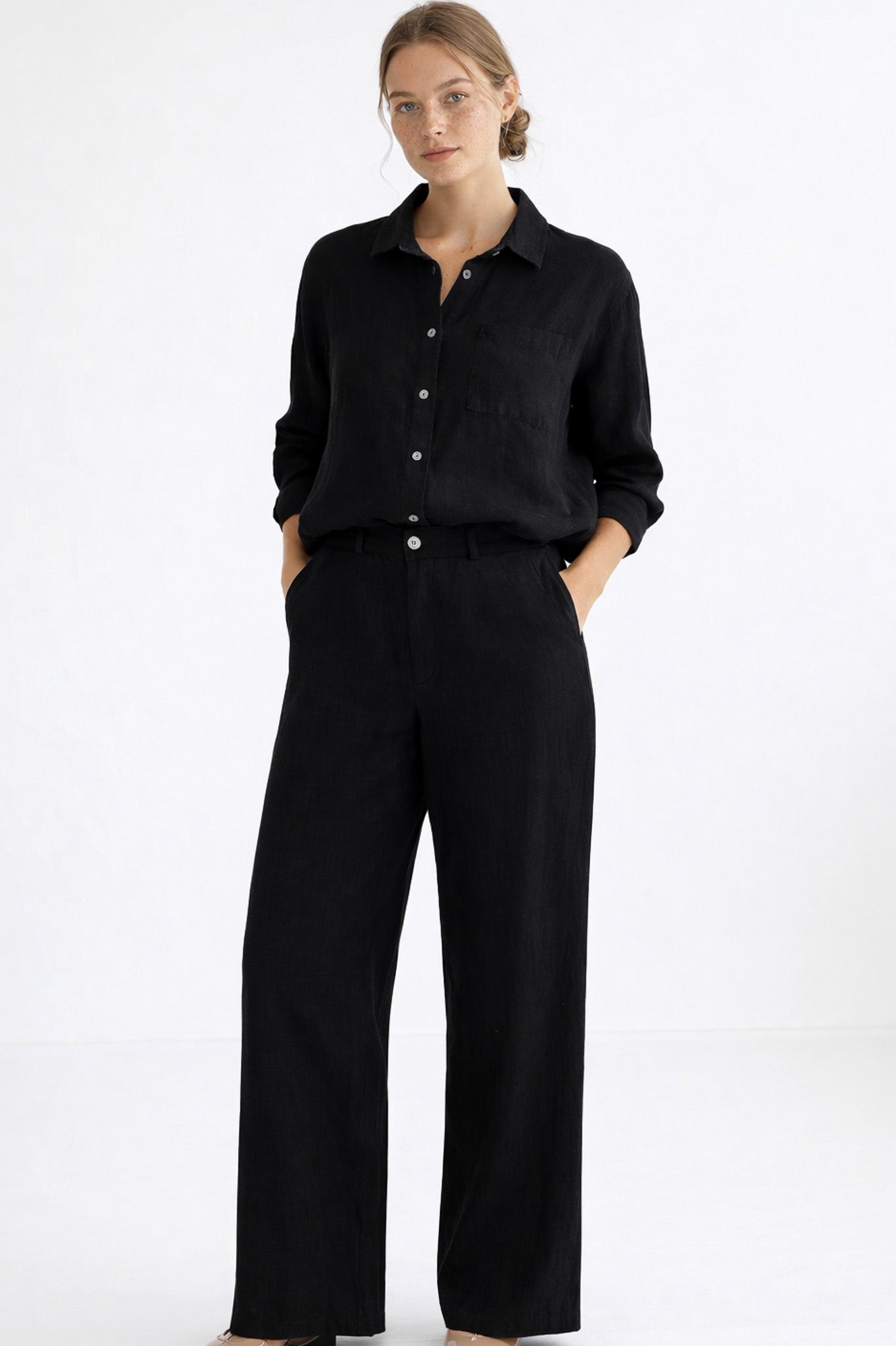 Woman wearing a black outfit on a white background