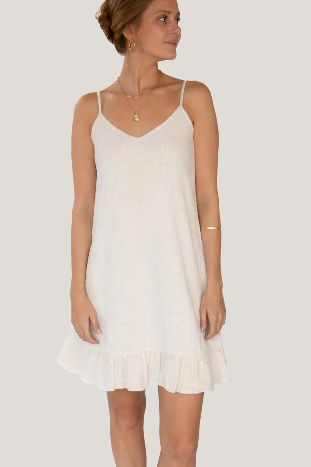 Woman wearing a white dress on a white background