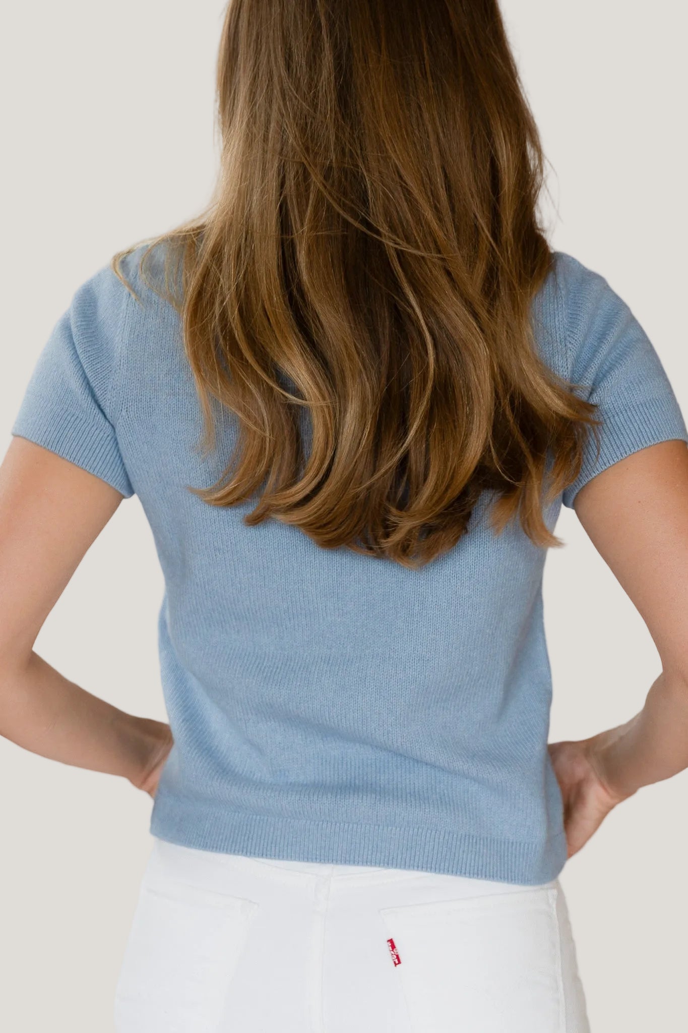 Person wearing a blue shirt with a white background